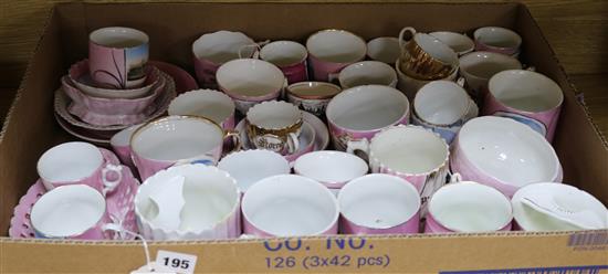 A collection of pink lustre, white-glazed and gilt souvenir china cups, mugs, small bowls and dishes (40, faults)